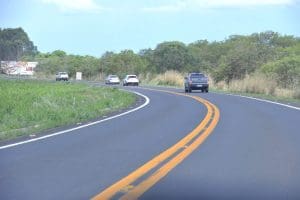 Imagem Rodovia, carros aparecem em uma curva da pista