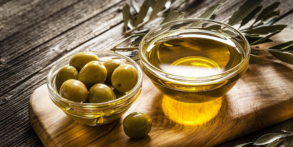 Imagem azeitonas em uma travessa de vidro e Azeite em outro recipiente