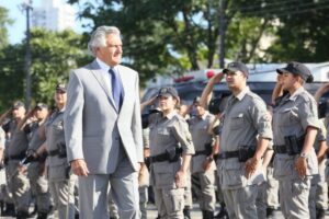 Imagem governador Ronaldo Caiado passando por policiais militares em forma e batendo continência