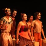 Imagem atores com rosto pintado em cima do palco no Teatro