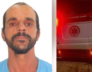 Imagem homem de barba e camisa azul ao lado uma ambulância de SAMU