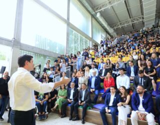 Imagem homem de camisa branca falando para o publico