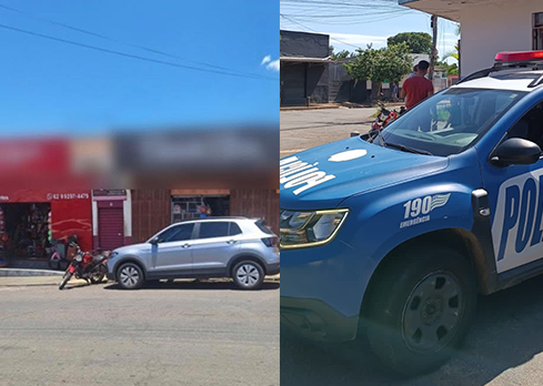 Imagem desfocada frente de loja, ao lado viatura da Policia Militar