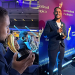 Imagem homem de terno beijando troféu