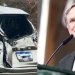 Imagem carro destruído ao lado homem de terno gravata vermelha