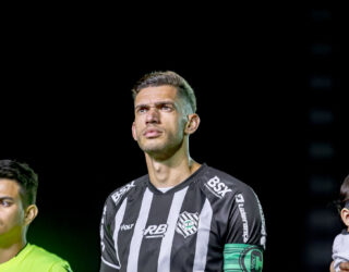 Imagem jogador com camisa listrada em preto e branco