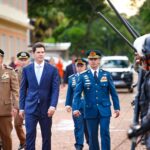 Imagem homem de terno caminhado ao lado de policiais