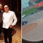 Imagem dois homens abraçados ao lado rodovia com acidente